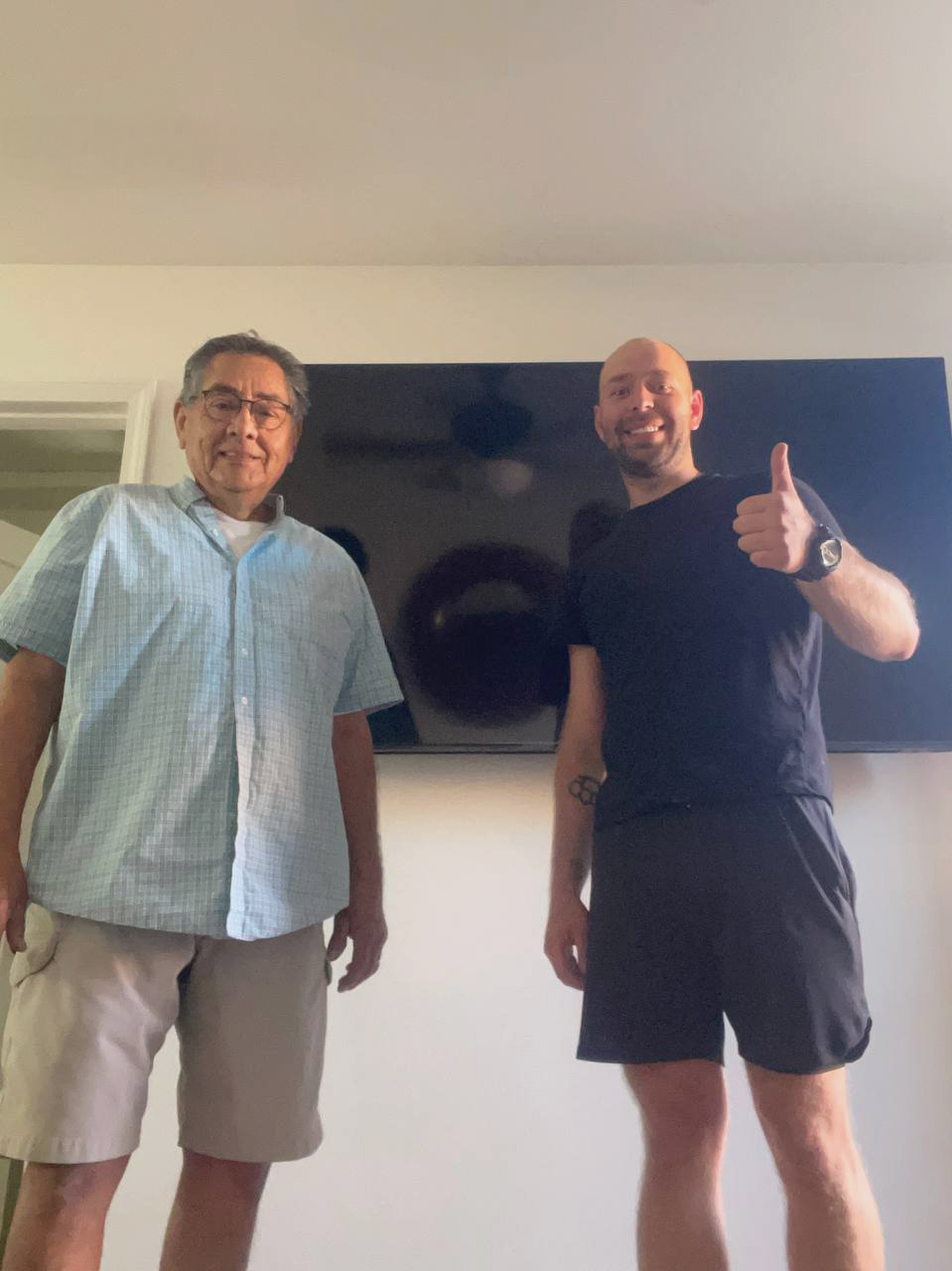 Our master with a TV installed on the wall and a satisfied customer